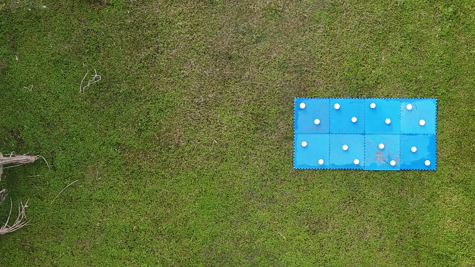 Blue calibration mat with sixteen white bowls, seen from a UAV at 15 m